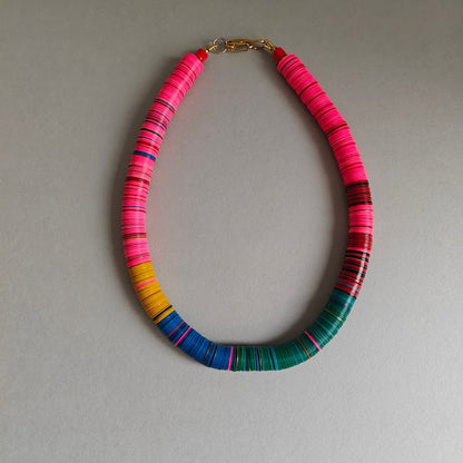 Necklace with colorful beads on a gray background
