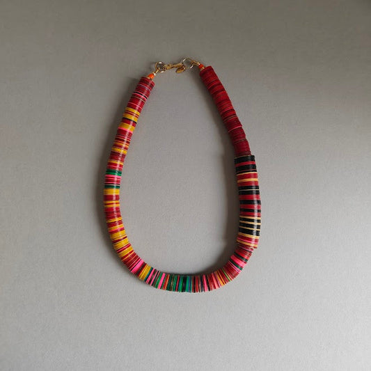 Necklace with multicolored beads on a gray background