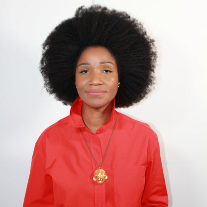 Person wearing a red outfit with a gold necklace on a white background