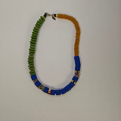 Necklace with green,yellow, and blue beads on a light gray background