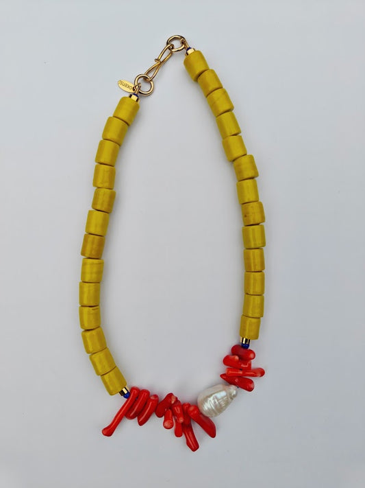 Necklace with yellow beads,freshwater baroque pearl bead  and coral on a blue background