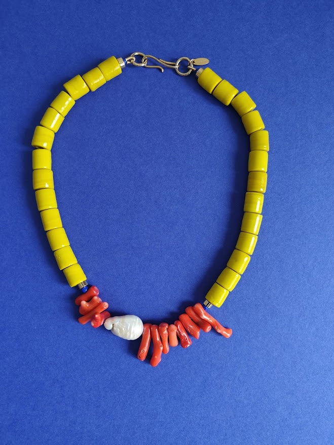 Necklace with yellow beads,freshwater baroque bead  and coral on a blue background