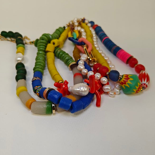 Colorful beaded necklaces on a white background