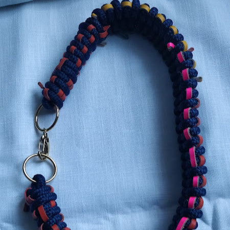 Close-up of irregular rope-and-leather weave with gold-plated lobster clasp